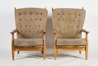 pair of mid - century danish lounge chairs with upholstered cushions
