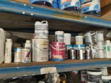 many cans and cans of paint on a shelf