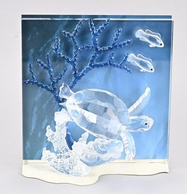 a picture of a glass sculpture of a fish and coral