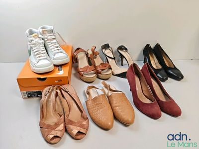 several pairs of women ' s shoes are lined up on a table