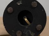 a small black object on a wooden table