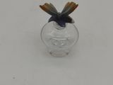 a small glass vase with a small insect inside of it