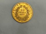 a close up of a gold coin on a gray surface