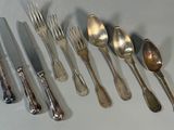 a lot of spoons and forks that are on the table