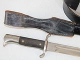 a knife and a belt laying on a table