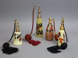 several different types of perfume bottles with tassels on a white surface