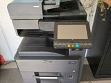 a stack of multi - function printers sitting on a tiled floor