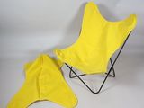 a yellow butterfly chair and a yellow umbrella on a white background