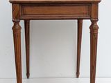 a small wooden desk with a drawer on top of it