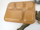 a brown tray with six compartments and a green strap