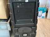 a black computer tower with a monitor on top of it