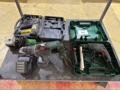 a box with a drill and other tools on a table