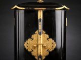 a black and gold decorated box with a cross on it