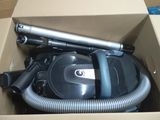 a box with a vacuum and a hose inside of it