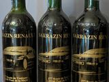 three bottles of wine sitting on top of a wooden table