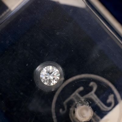 a single diamond in the middle of a clear box