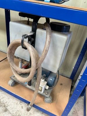 a hose attached to the side of a workbench