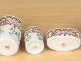 five cups sitting next to each other on a table