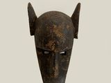an image of a wooden mask with horns on a white background