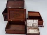 three wooden boxes that are open on a white surface