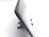 a tablet computer sitting on a stand on a white surface