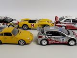 several toy cars are lined up in a row on a white surface