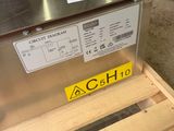 an image of a stainless steel dishwasher sitting on a pallet in a warehouse