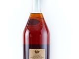 a bottle of brandy sitting on top of a white surface