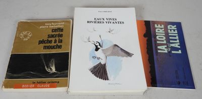 three books sitting on top of a white table next to each other