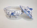 two blue and white dishes with lids on a white surface