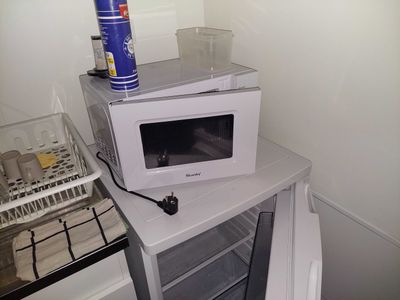 a microwave oven sitting on top of a small table