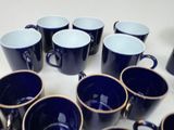 a lot of blue coffee cups sitting on a table