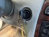 a car dashboard with a key in it and a keychain on the steering wheel