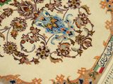 a close up of a rug with a bird and flowers on it