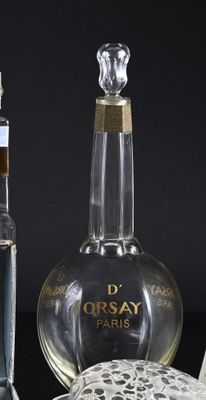 a bottle of perfume next to a bottle of perfume on a table