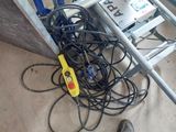 a pile of wires and wires on the ground next to a ladder