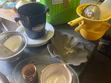 a table that has many bowls and cups on it