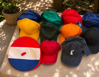 many hats that are sitting on a table