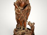 a statue of a man with a dog on a pedestal