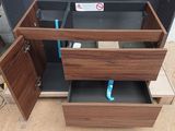 a wooden cabinet with two drawers on top of it