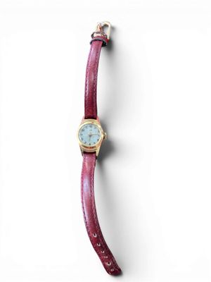 a close up of a watch on a white surface with a white background