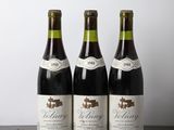 three bottles of wine sitting on top of a wooden table