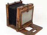 an old wooden camera with a mirror on top of it
