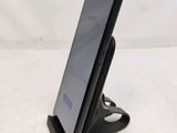 a close up of a cell phone on a stand on a table