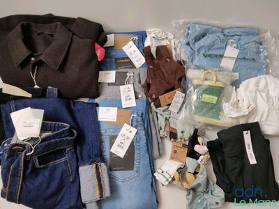a lot of clothing that is sitting on a table