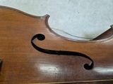 a close up of a violin that is sitting on the floor