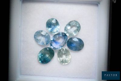 an image of a picture of a flower made of blue and green gems