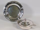 silver plate with a lid and a bowl on a white surface