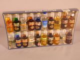 many bottles of alcohol in a box on a table
