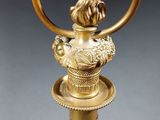 an antique brass table lamp with a glass shade on top of it
